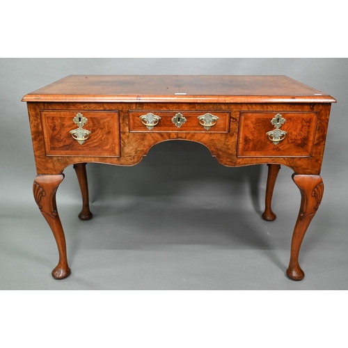 887 - A Georgian style cross and feather-banded quarter veneered walnut side table with three drawers with... 