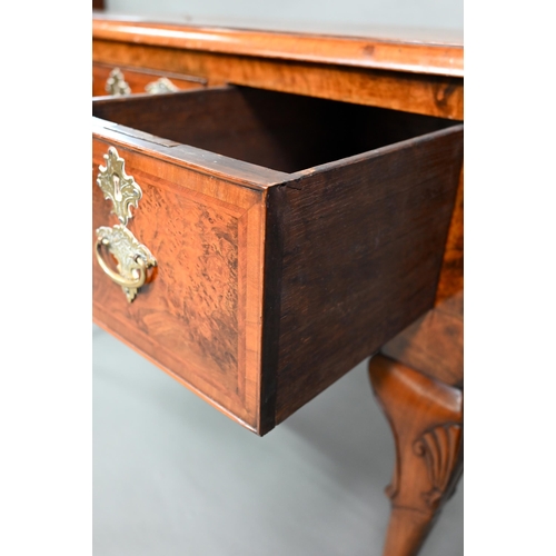 887 - A Georgian style cross and feather-banded quarter veneered walnut side table with three drawers with... 