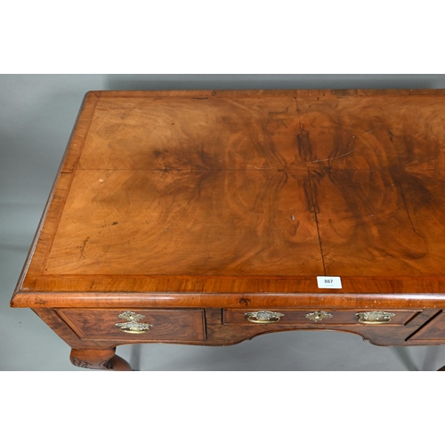 887 - A Georgian style cross and feather-banded quarter veneered walnut side table with three drawers with... 