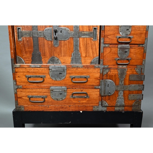 888 - An antique Japanese steel bound softwood ledger chest, with an arrangement of drawers around a slide... 