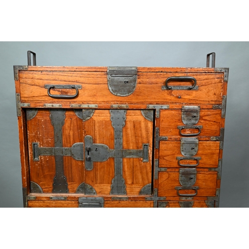 888 - An antique Japanese steel bound softwood ledger chest, with an arrangement of drawers around a slide... 