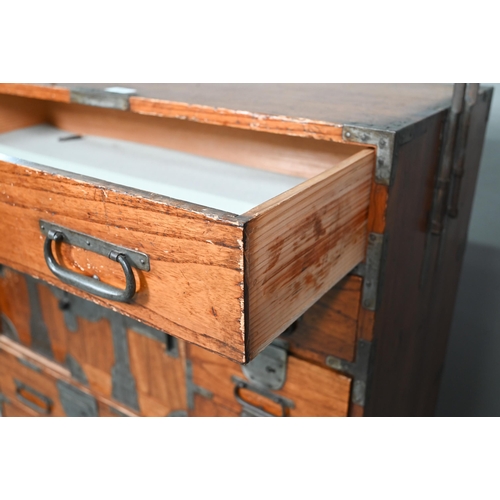 888 - An antique Japanese steel bound softwood ledger chest, with an arrangement of drawers around a slide... 