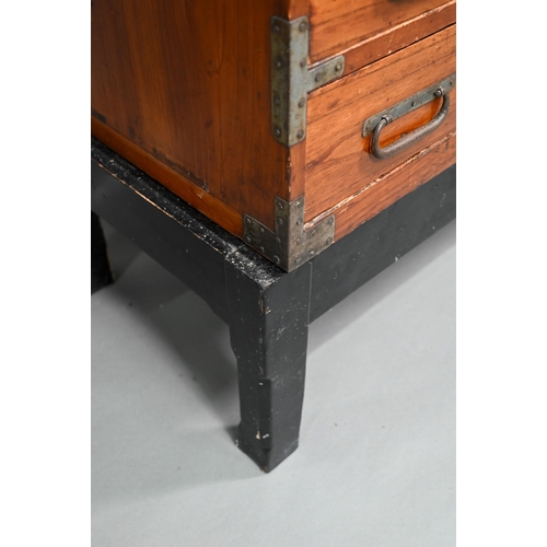 888 - An antique Japanese steel bound softwood ledger chest, with an arrangement of drawers around a slide... 