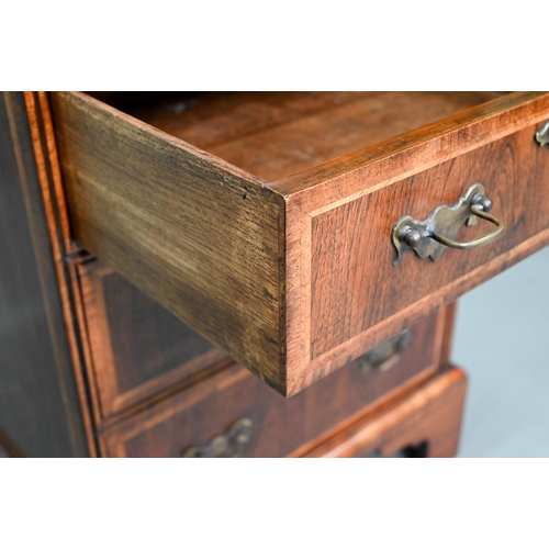 889 - A well executed Georgian style small cross and feather-banded walnut chest of four drawers beneath a... 