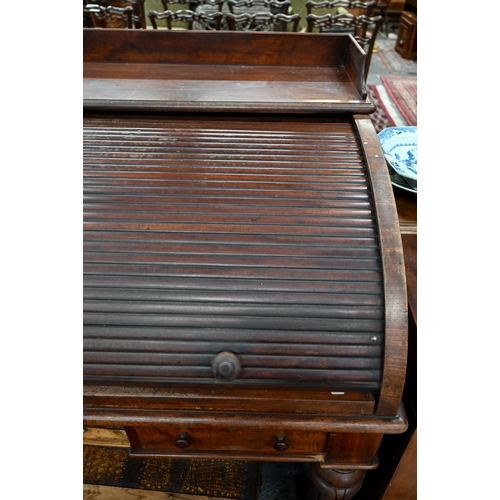 891 - A William VI mahogany cylinder top desk, the 3/4 gallery top over a leather top slide and stationary... 