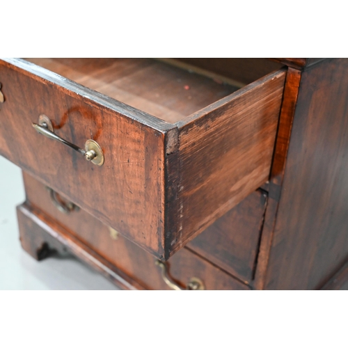 892 - A small Georgian cross-banded mahogany chest of three long drawers, raised on shaped bracket, 68 cm ... 