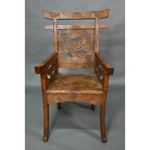 897 - A Japanese Arts & Crafts Liberty armchair, constructed in sections and carved with sunflowers