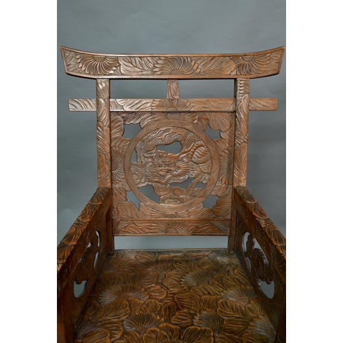 897 - A Japanese Arts & Crafts Liberty armchair, constructed in sections and carved with sunflowers