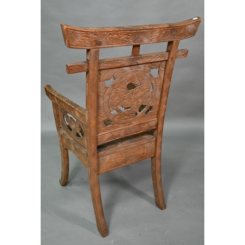 897 - A Japanese Arts & Crafts Liberty armchair, constructed in sections and carved with sunflowers