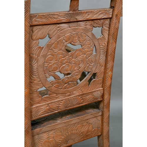 897 - A Japanese Arts & Crafts Liberty armchair, constructed in sections and carved with sunflowers