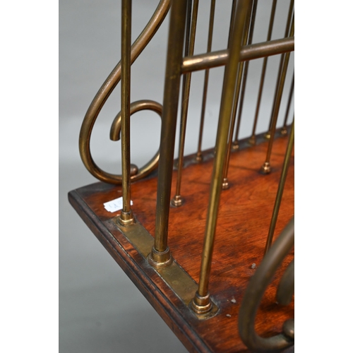 899 - An antique cast iron, brass and mahogany revolving newspaper stand, raised on paw feet