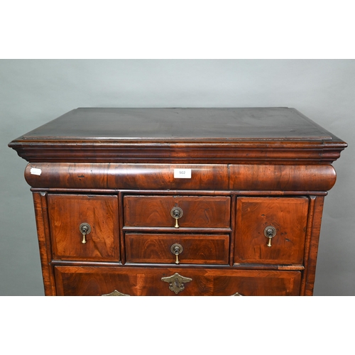 902 - A Queen Anne period and later altered feather banded walnut chest on stand, the moulded cornice over... 