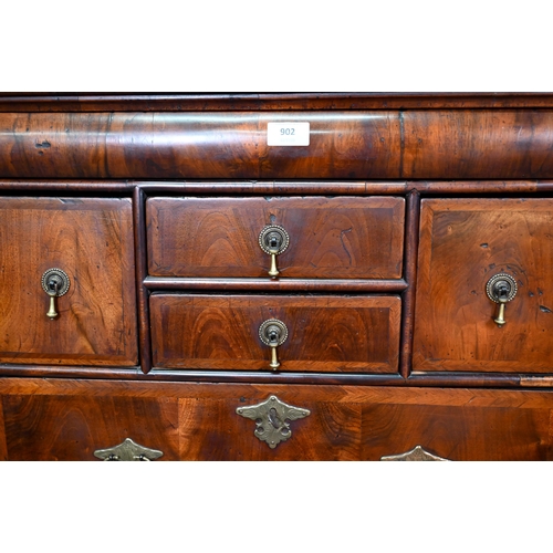 902 - A Queen Anne period and later altered feather banded walnut chest on stand, the moulded cornice over... 