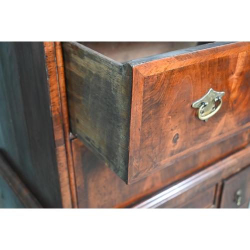 902 - A Queen Anne period and later altered feather banded walnut chest on stand, the moulded cornice over... 