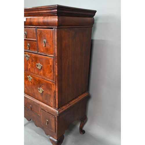 902 - A Queen Anne period and later altered feather banded walnut chest on stand, the moulded cornice over... 