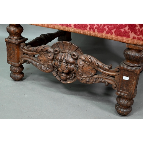 903 - A Victorian carved and moulded oak framed throne chair, with remnants of plush fabric back and seat ... 