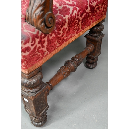 903 - A Victorian carved and moulded oak framed throne chair, with remnants of plush fabric back and seat ... 