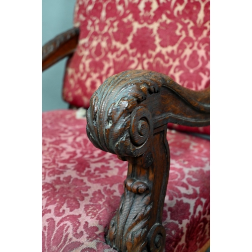 903 - A Victorian carved and moulded oak framed throne chair, with remnants of plush fabric back and seat ... 