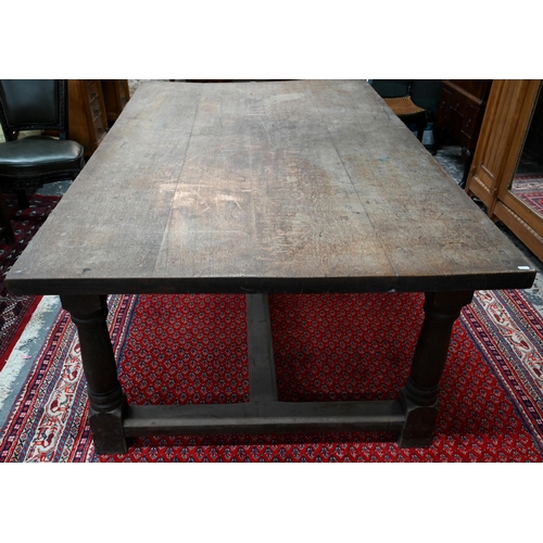 908 - An antique oak refectory table, the wide four plank top over a plain frieze and joint frame with tur... 