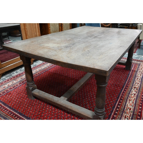 908 - An antique oak refectory table, the wide four plank top over a plain frieze and joint frame with tur... 