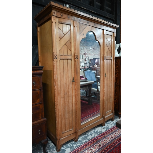 A close matched Arts & Crafts Gothic Reform inlaid Ash four part bedroom suite in the manner of Charles Bevan, comprising a combination wardrobe with castellated cornice, centred by an arched mirror panelled door, 162 cm w x 64 cm x 216 cm h; a mirror backed dressing table with recessed Minton tiled footwell, 138 cm w x 61 cm x 165 cm h; a  chest of two short over four long graduated drawers, 117 cm w x 56 cm x 121 cm h; a single door pot cupboard, 43 cm w x 33 cm x 82 cm h and a double bed frame (altered) - all original but at fault (5)