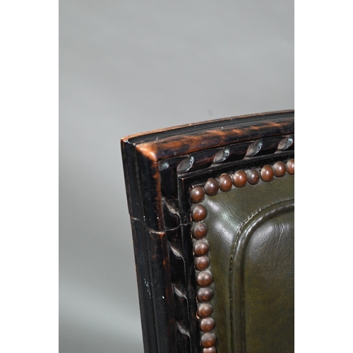 912 - A pair of antique French Empire green studded leather side chairs, with moulded ebonised walnut fram... 