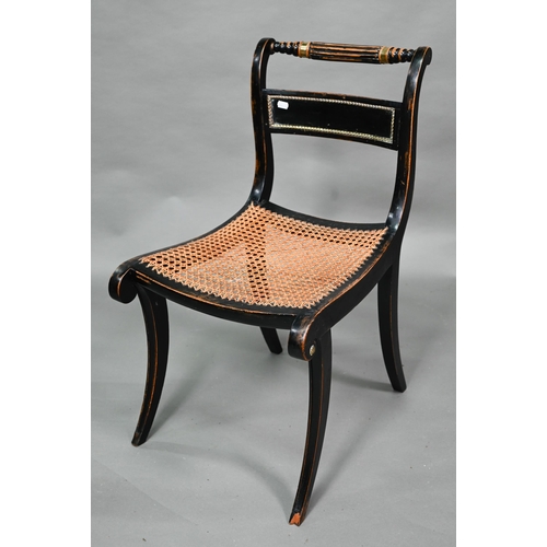 914 - A pair of Regency brass mounted ebonised framed cane seat side chairs, on sabre front legs (2)