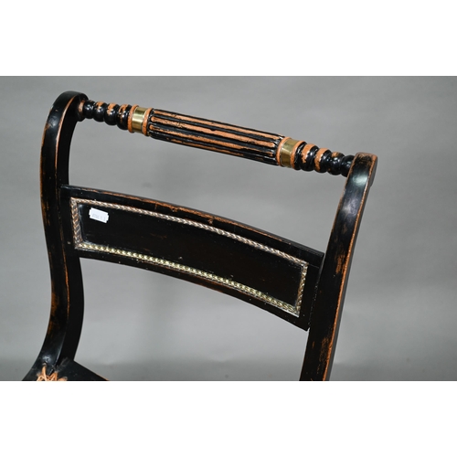 914 - A pair of Regency brass mounted ebonised framed cane seat side chairs, on sabre front legs (2)