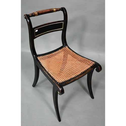 914 - A pair of Regency brass mounted ebonised framed cane seat side chairs, on sabre front legs (2)