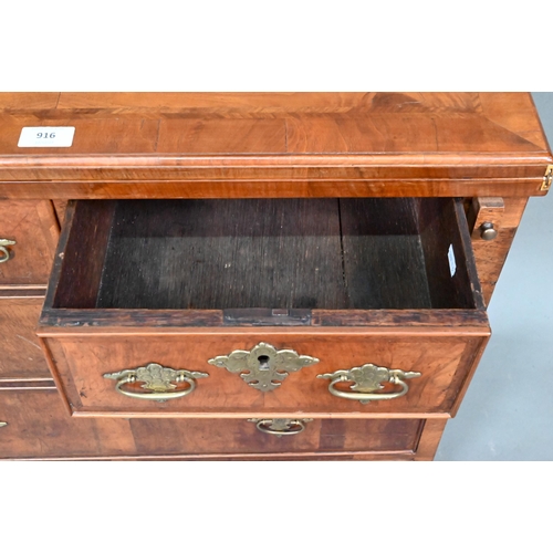 916 - An 18th century feather-banded walnut bachelors chest, the fold over top over two short and three lo... 