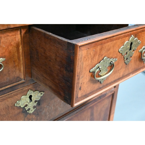 916 - An 18th century feather-banded walnut bachelors chest, the fold over top over two short and three lo... 