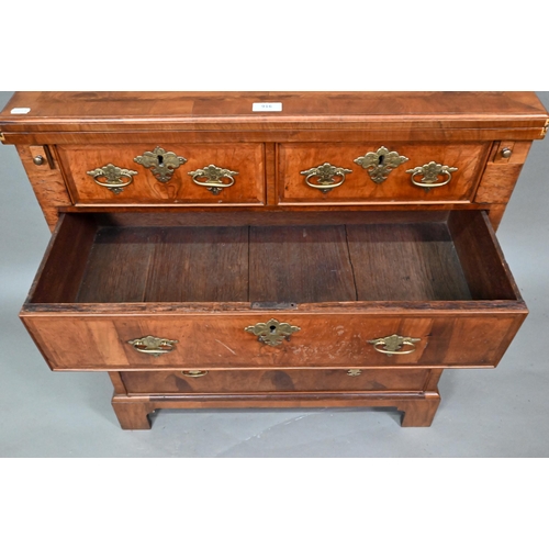 916 - An 18th century feather-banded walnut bachelors chest, the fold over top over two short and three lo... 