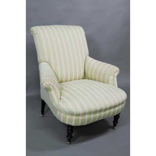 917 - A late Victorian armchair, well re-upholstered in striped pale green/red fabric, raised on castors