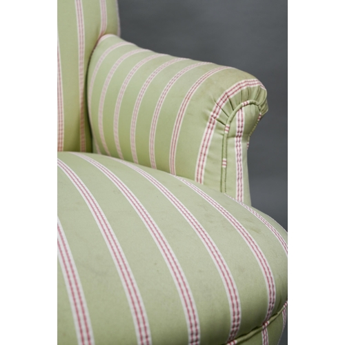 917 - A late Victorian armchair, well re-upholstered in striped pale green/red fabric, raised on castors