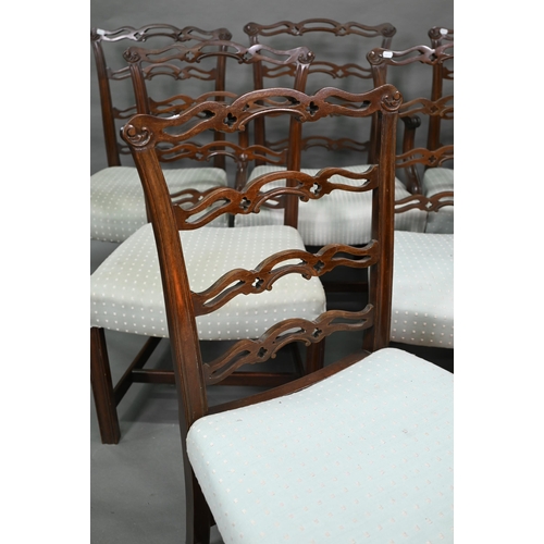 919 - A set of eight Georgian style walnut dining chairs with pierced wavy splats over overstuffed seats o... 