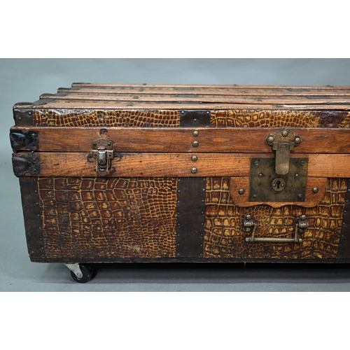 920 - A vintage steel and wood bound crocodile skin panelled trunk, with leather carrying handles, 92 cm w... 