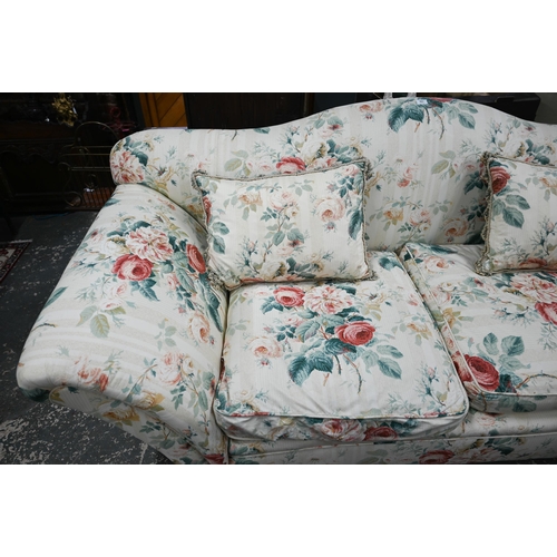 921 - A Georgian style hump back scroll arm sofa, in floral Colefax & Fowler fabric, raised on three f... 