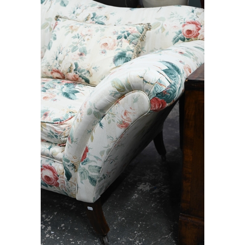 921 - A Georgian style hump back scroll arm sofa, in floral Colefax & Fowler fabric, raised on three f... 