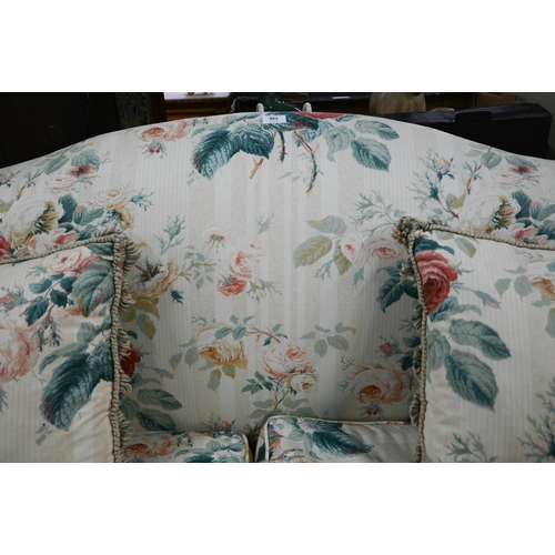 921 - A Georgian style hump back scroll arm sofa, in floral Colefax & Fowler fabric, raised on three f... 