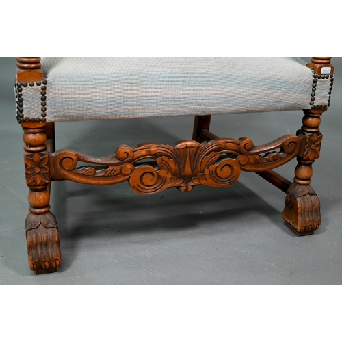 923 - A continental moulded walnut framed blue embroidered dove design panelled open armchair