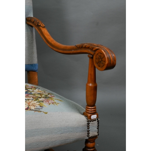 923 - A continental moulded walnut framed blue embroidered dove design panelled open armchair