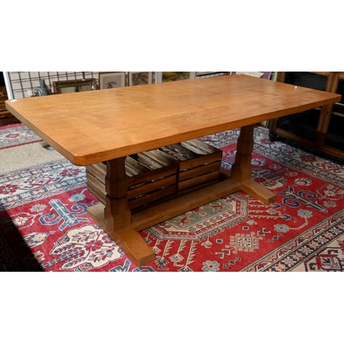 Robert 'Mouseman' Thompson, an oak dining table, the rectangular adzed top raised two large octagonal legs, one carved with signature mouse, united by a floor level centre stretcher,