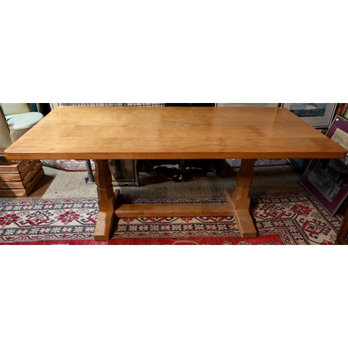 927 - Robert 'Mouseman' Thompson, an oak dining table, the rectangular adzed top raised two large octagona... 