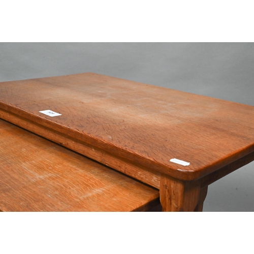 929 - Robert Thompson, Kilburn, a nest of three graduating oak 'Mouseman' coffee tables, each with adzed t... 