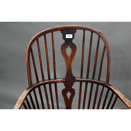 933 - A 19th century yew and elm seat Windsor stick-back elbow chair, the arms carved with various student... 