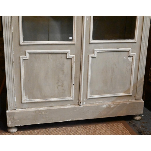 937 - A continental part glazed distressed painted cabinet, raised on bun feet, 140 cm w x 41 cm x 216 cm ... 