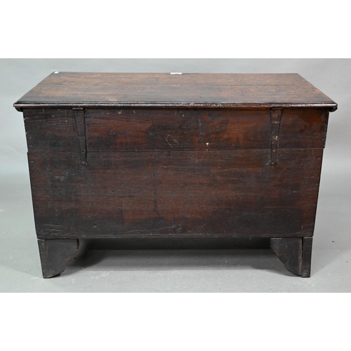 938 - A small oak mule chest, the two plank top over a twin panel front carved 'H C 1699', over a and full... 