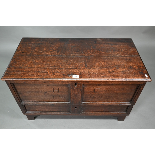 938 - A small oak mule chest, the two plank top over a twin panel front carved 'H C 1699', over a and full... 