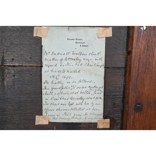 938 - A small oak mule chest, the two plank top over a twin panel front carved 'H C 1699', over a and full... 