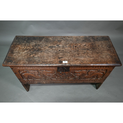 939 - A 17th century oak six plank coffer, with iron staple lock and key, the relief carved front centred ... 